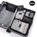 Black travel packing cubes with 'Secret Pouch' labels inside an open suitcase.