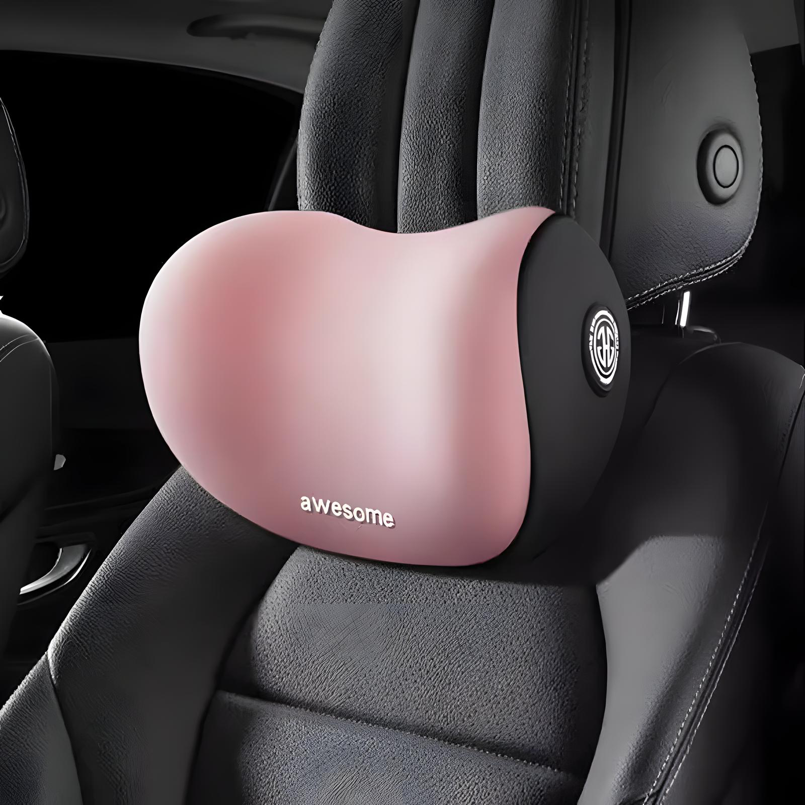 A pink and black car seat neck pillow with the word 'awesome' printed on it, shown resting on a black leather car seat.