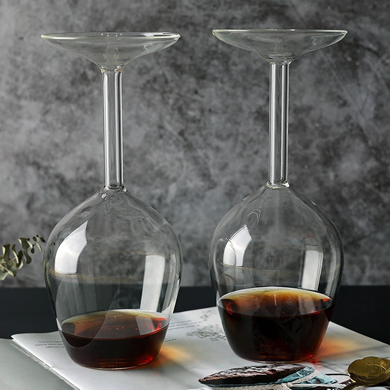 Two glass decanters with liquid on a marble surface with a gray marble background