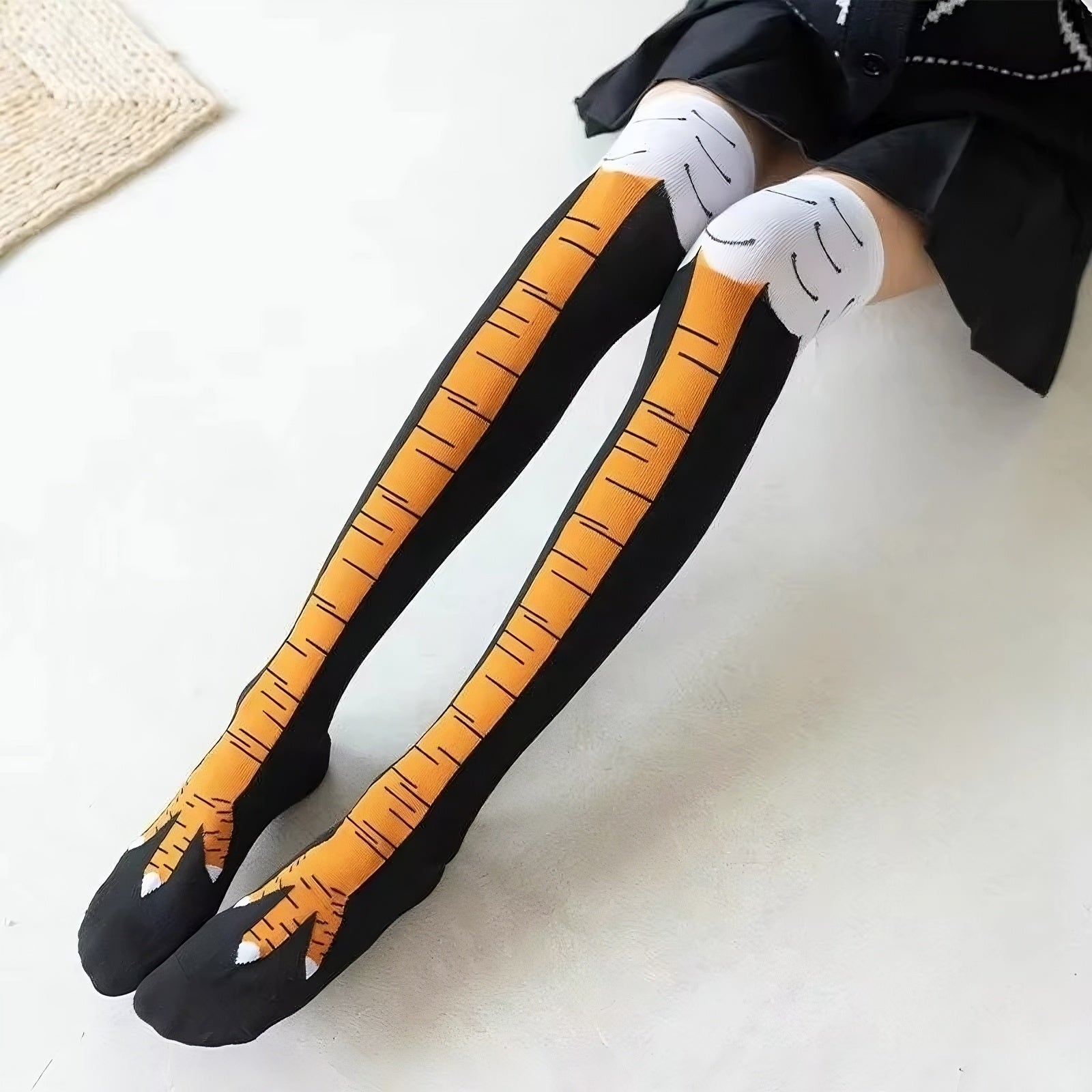 Black tights with orange tiger stripes and white paw prints on a white background