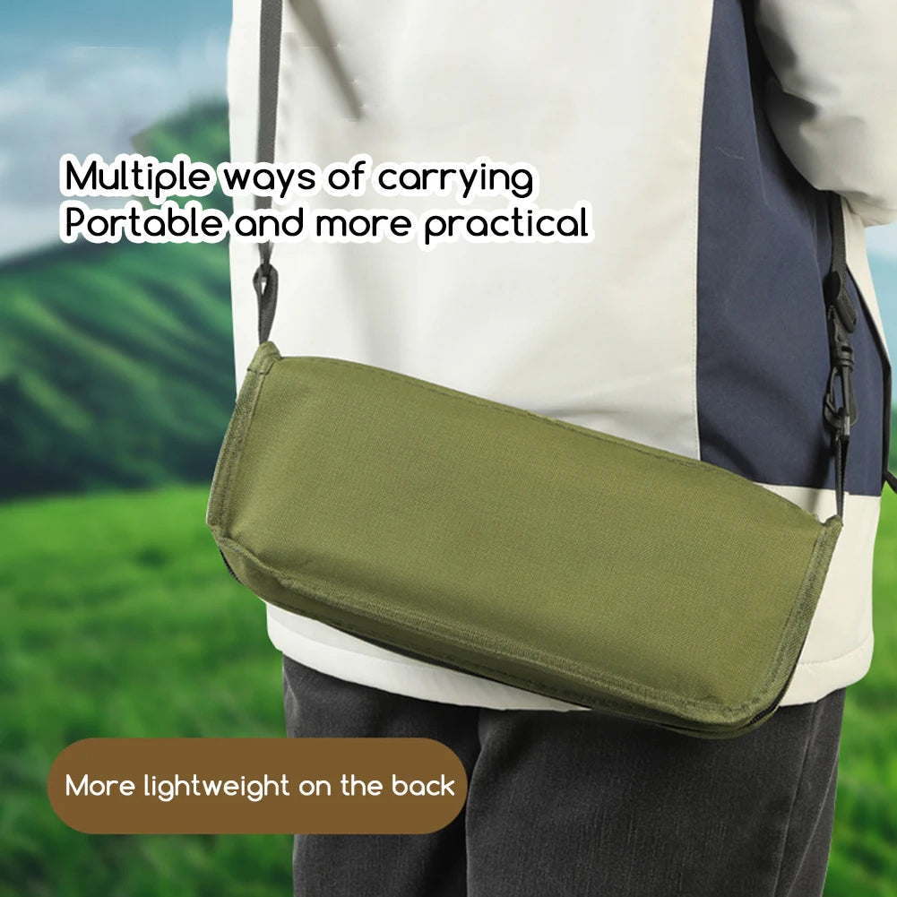 Person carrying a green crossbody bag with scenic background