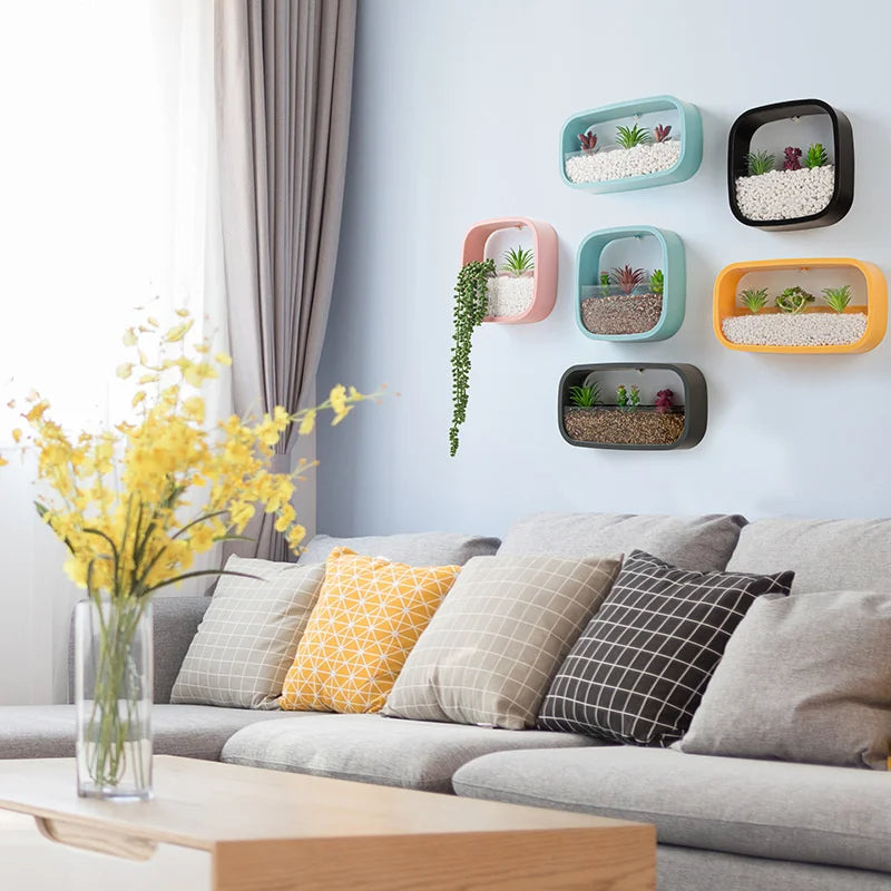 Living room with a gray sofa, decorative pillows, and wall-mounted planters.