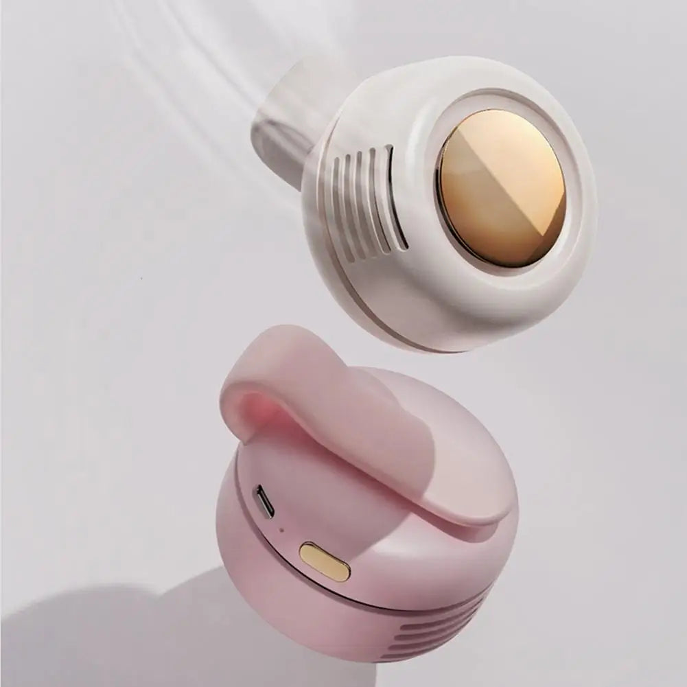 Pink and white earbuds with gold accents on a light gray background