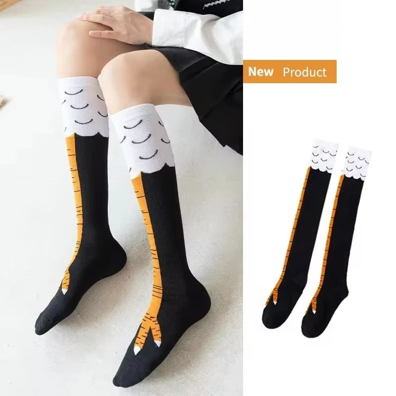 Black socks with cartoonish bird feet design worn by a person, with a close-up of the socks on the right.