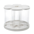 A white and clear plastic 6-compartment organizer with a flower-shaped top and a round base, shown on a solid white background.