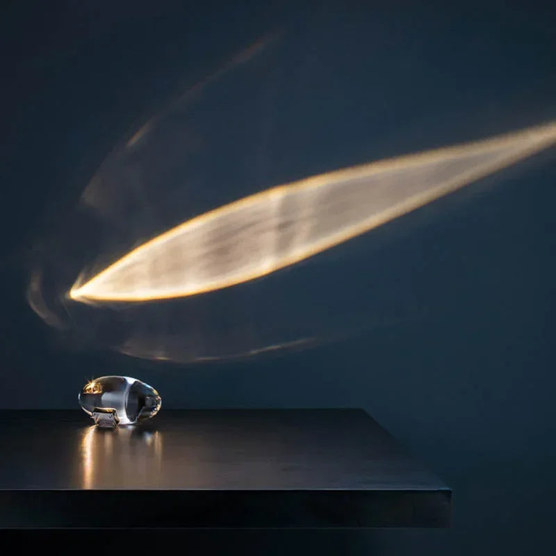 Crystal object on a dark surface with a light beam effect
