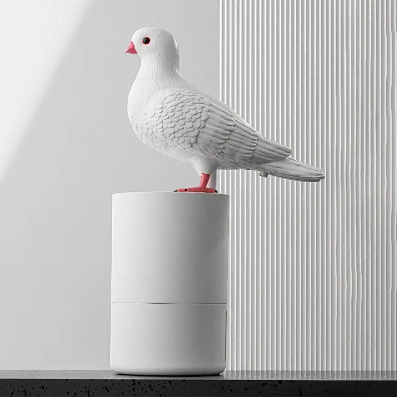 White ceramic pigeon on a cylindrical base against a light gray background