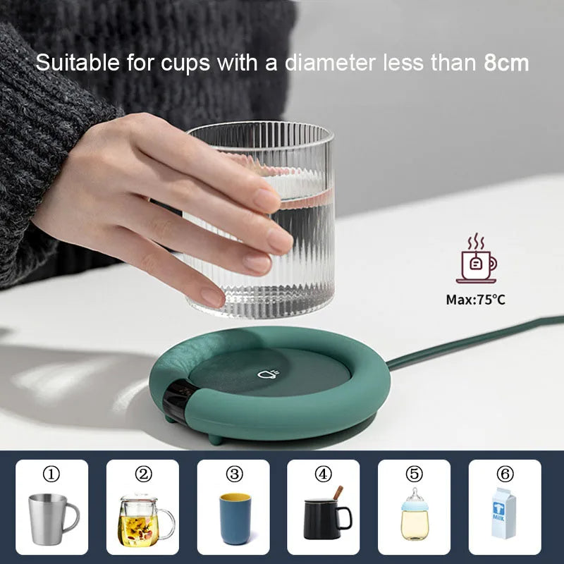 Green cup warmer with a glass of water on a white surface, hand holding the glass.