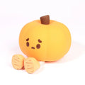 Plush toy shaped like a pumpkin with a sad face on a white background