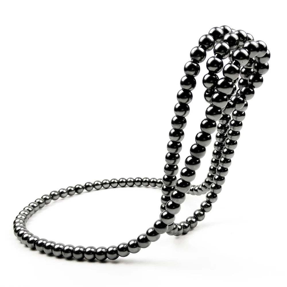 Three black beaded bracelets on a white background