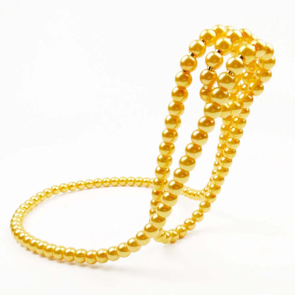 Two gold beaded bracelets on a white background