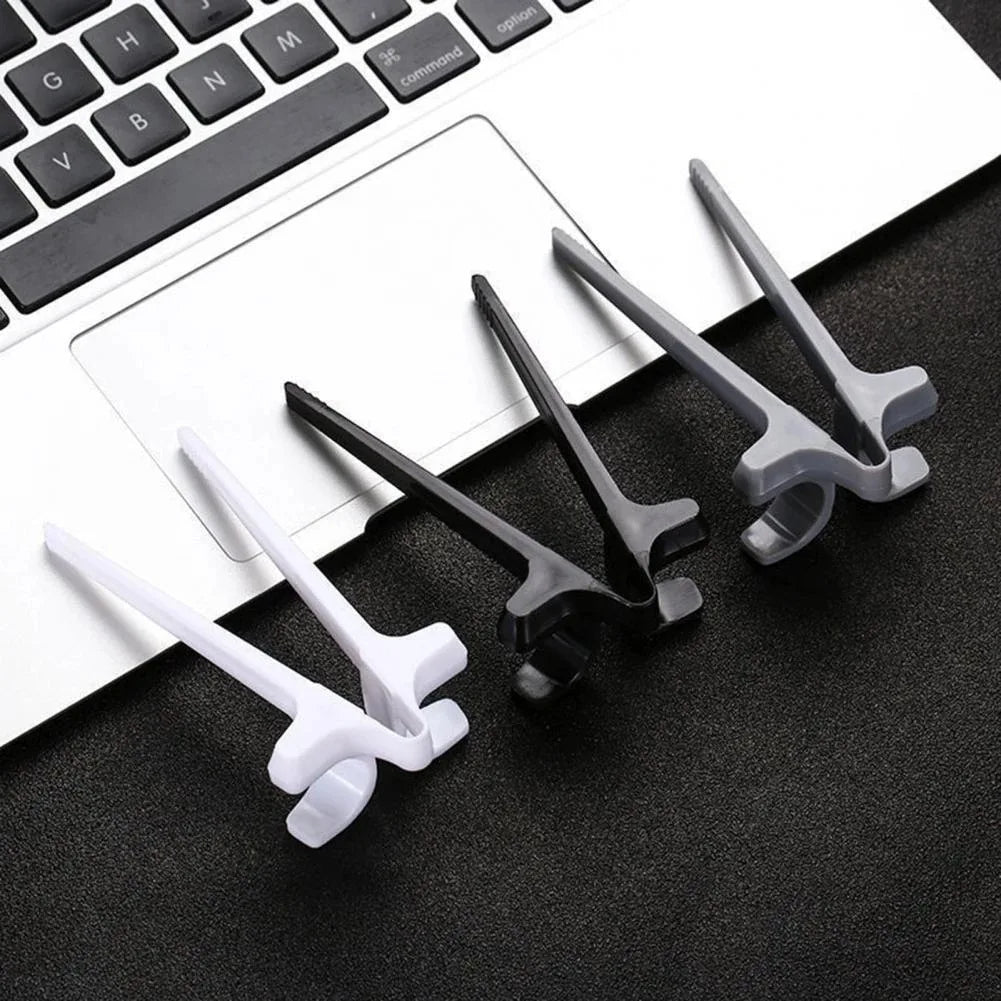 Set of small tools on a black surface with a laptop keyboard in the background