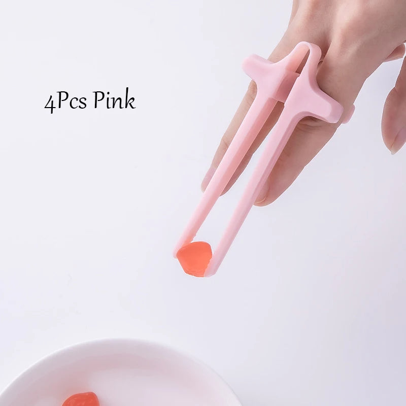 Pink tongs with red ends being held by a hand on a light gray background.