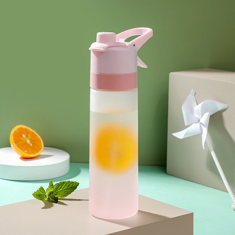 Clear water bottle with pink top on a green background
