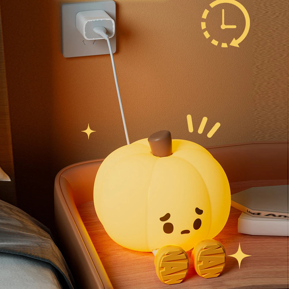 Yellow cartoon-style night light on a wooden surface with a wall socket in the background.