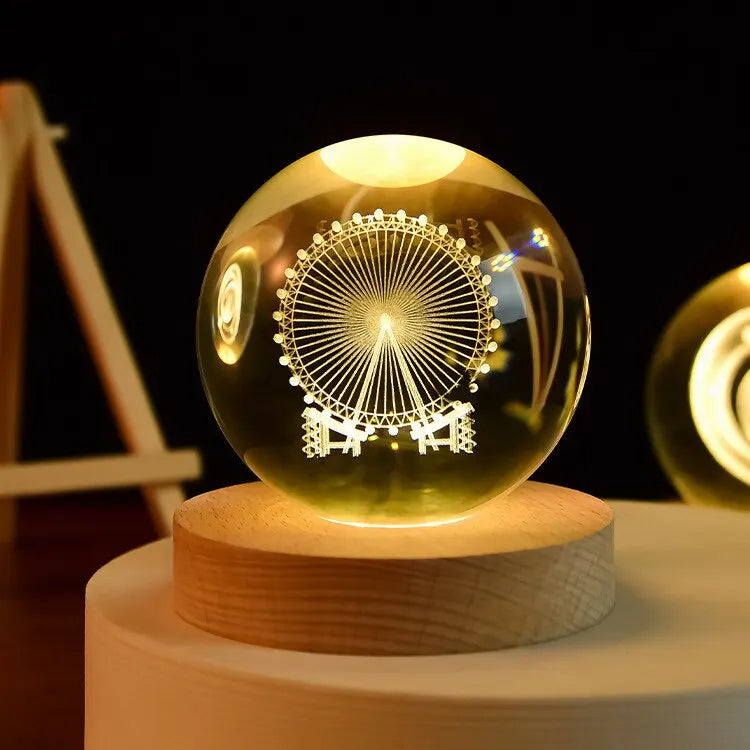 Glass ball with Ferris wheel design on a wooden base against a dark background