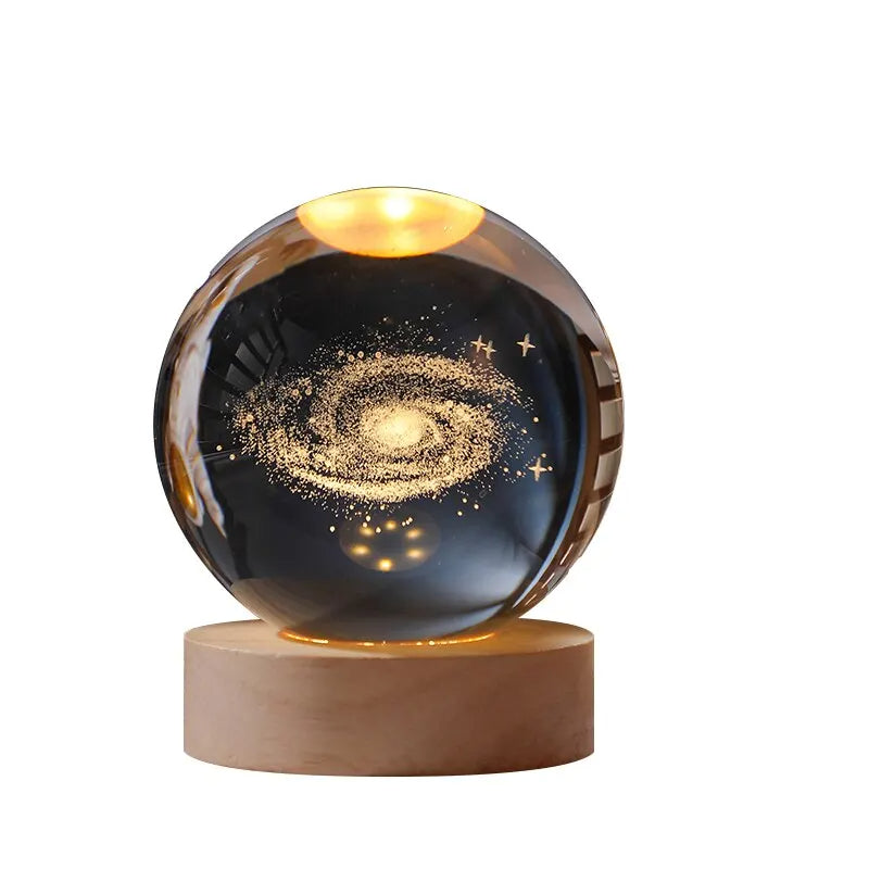 Glass sphere with galaxy design on a wooden base against a white background