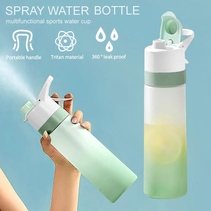 Spray water bottle with gradient design held by a hand against a light blue background