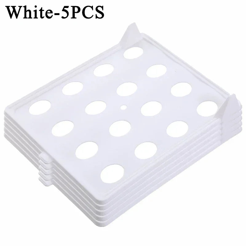 Stack of white plastic trays with multiple holes on a white background