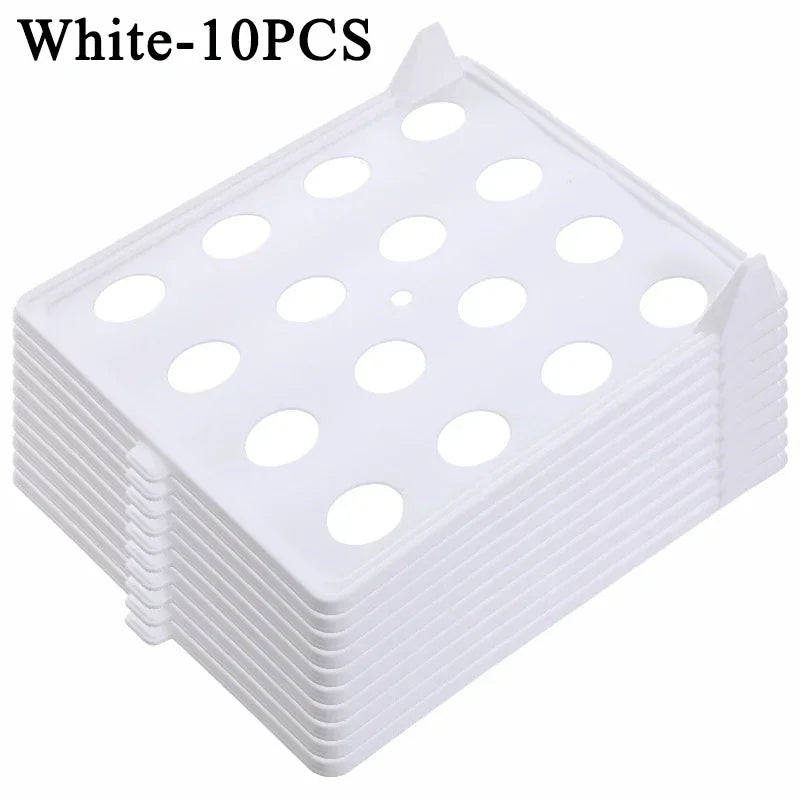 Stack of white plastic trays with holes on a white background