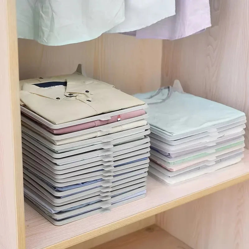 Stacks of folded shirts on a wooden shelf with a light background