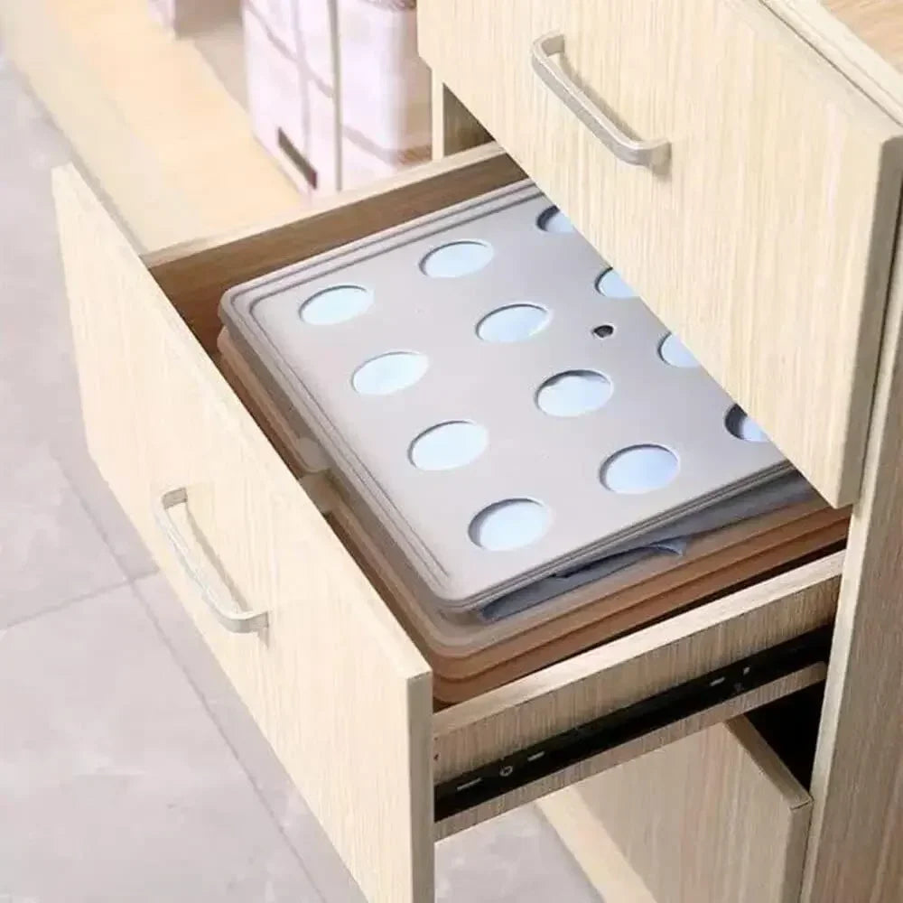Open kitchen cabinet with a cutting board and tray inside