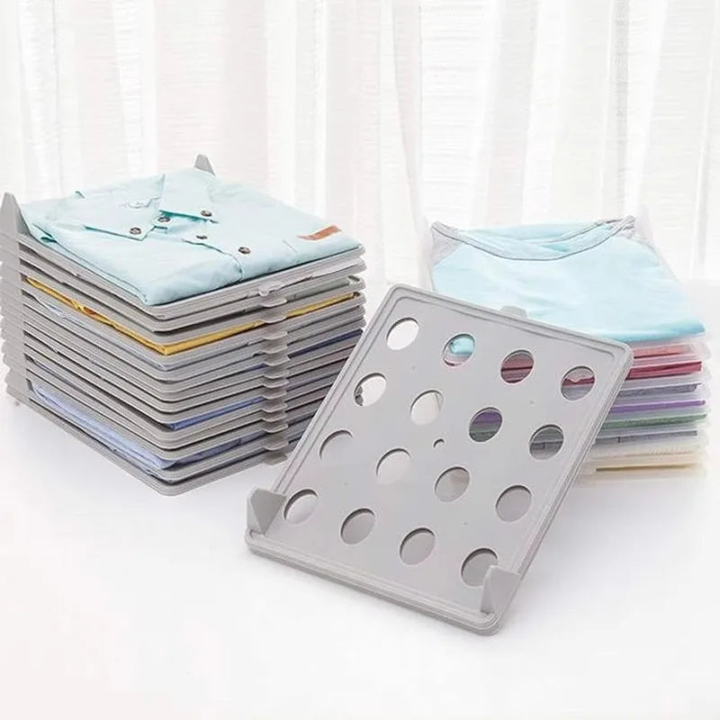 Stack of folded clothes with a gray garment organizer on a white background