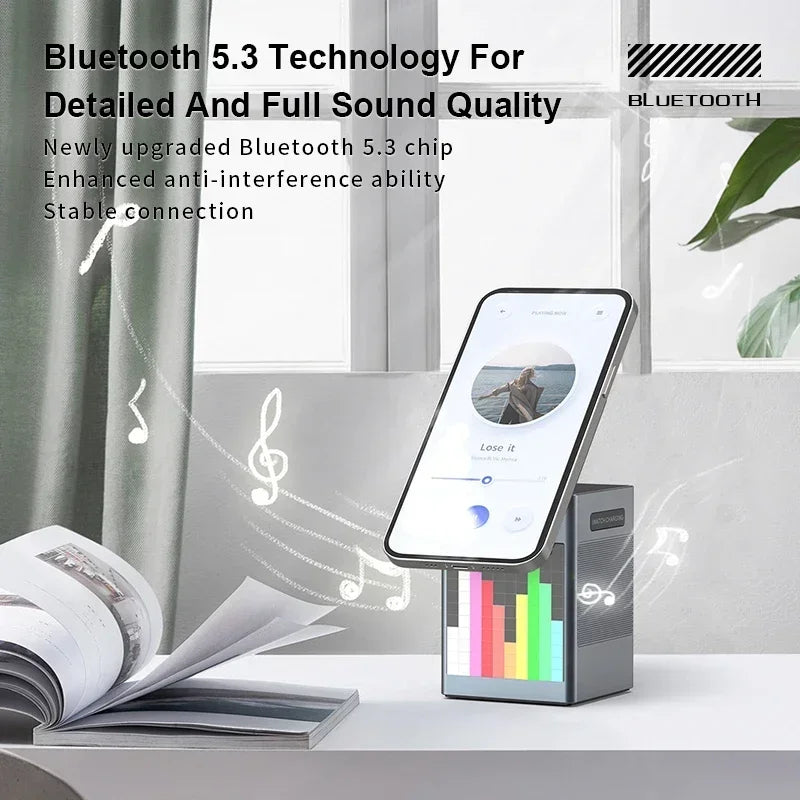 Phone dock with Bluetooth 5.3 technology on a desk with a book and plant in the background
