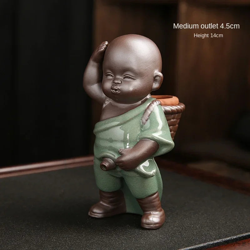 Small figurine of a child holding a basket on a dark surface