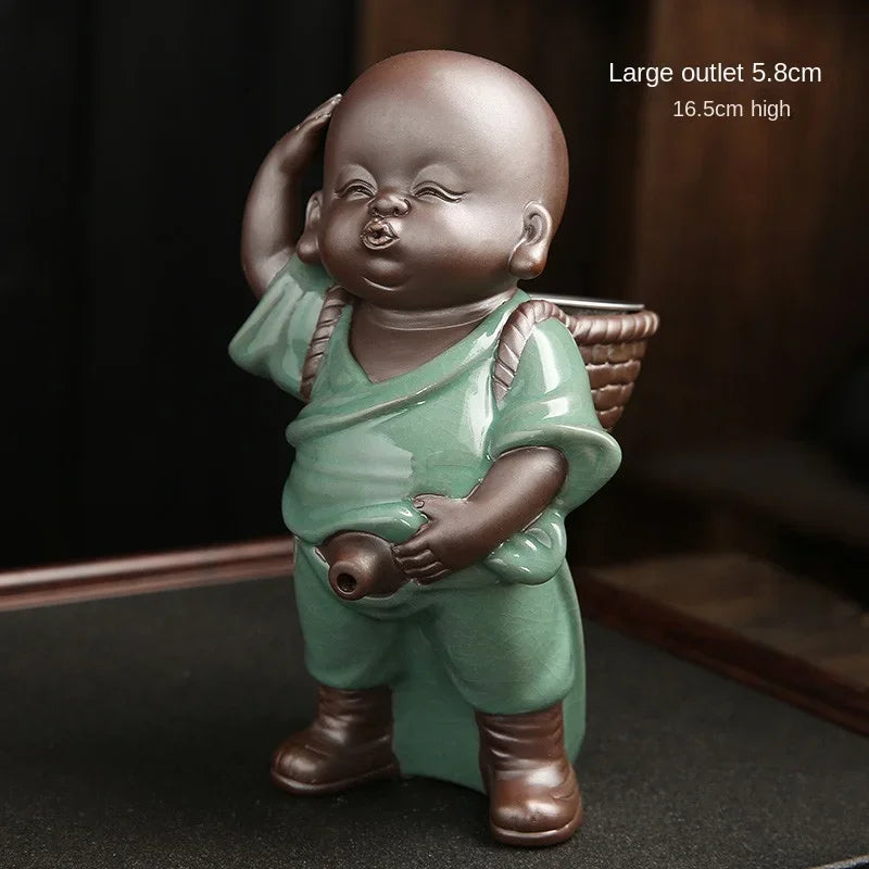 Small statue of a child in green robes holding a basket on a dark background