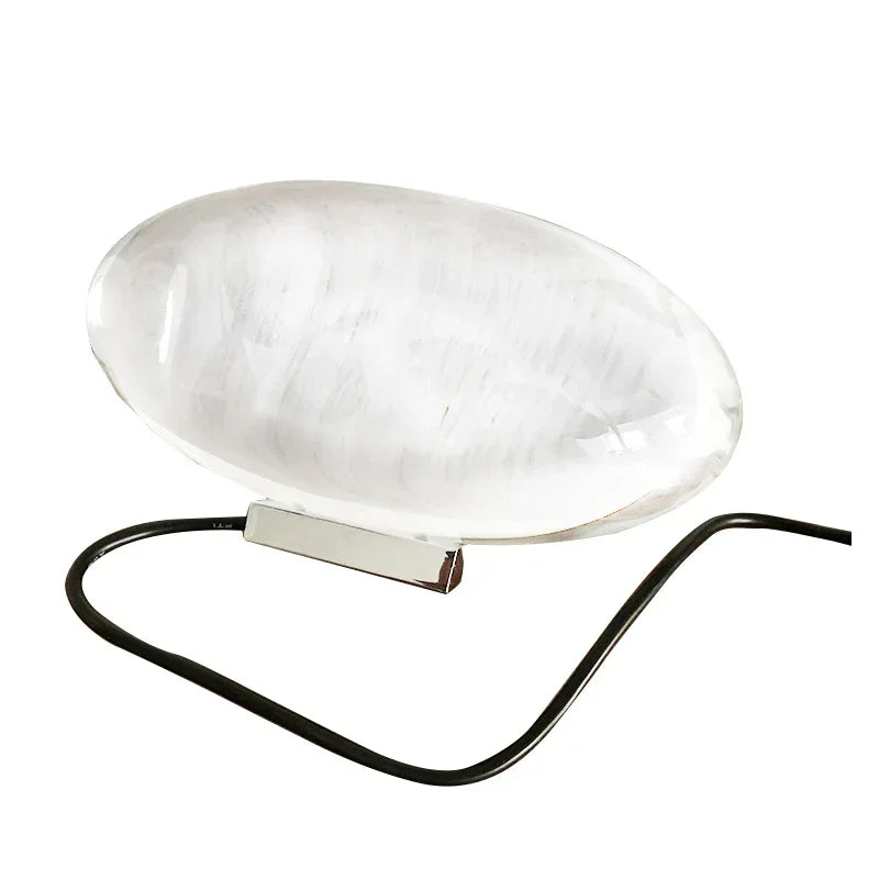 Clear dome-shaped object with a black base on a white background